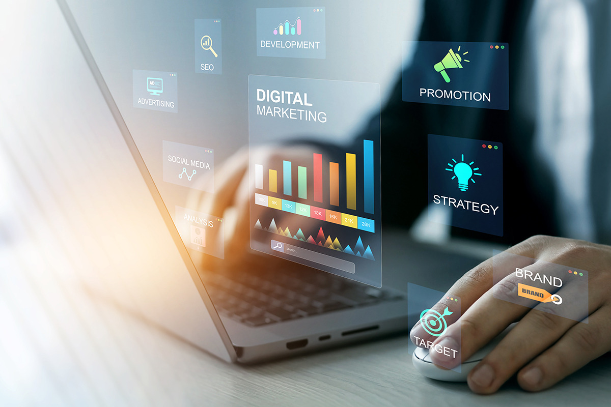 person on laptop with digital strategy icons hovering over it